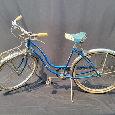 Sale Photo Thumbnail #185: Blue/teal Schwinn Fair Lady 3-speed with whitewall tires, full fenders, front rack, blue/white saddle, cream grips and bell. Complete and attractive vintage step-through bike with plenty of period style. Shows age to the saddle, chrome, spokes and tires a