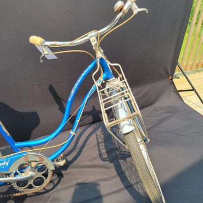 Sale Photo Thumbnail #178: Blue/teal Schwinn Fair Lady 3-speed with whitewall tires, full fenders, front rack, blue/white saddle, cream grips and bell. Complete and attractive vintage step-through bike with plenty of period style. Shows age to the saddle, chrome, spokes and tires a