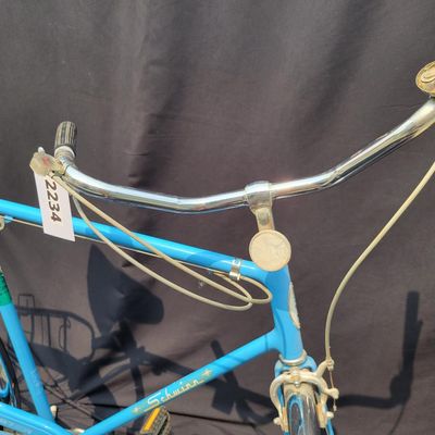 Sale Photo Thumbnail #190: Blue Schwinn Speedster with internal-gear drivetrain, full fenders, rear carrier, black saddle and rear reflector. Complete vintage rider showing paint chips, dull chrome, surface rust and older tires. A straightforward restoration or rider project with c