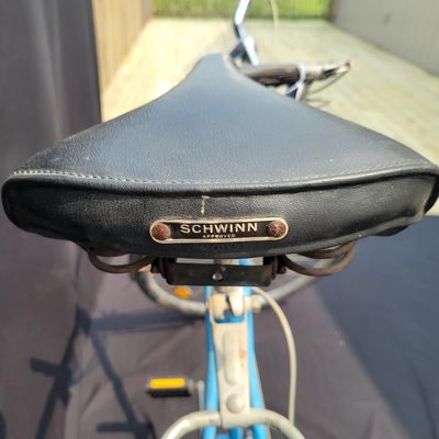 Sale Photo Thumbnail #194: Blue Schwinn Speedster with internal-gear drivetrain, full fenders, rear carrier, black saddle and rear reflector. Complete vintage rider showing paint chips, dull chrome, surface rust and older tires. A straightforward restoration or rider project with c