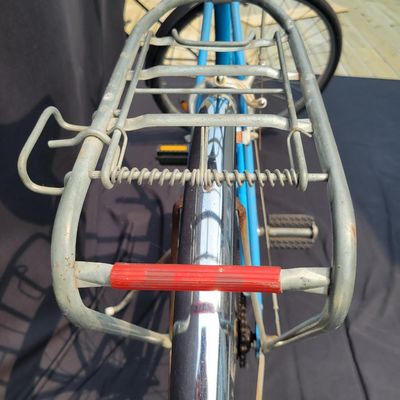 Sale Photo Thumbnail #193: Blue Schwinn Speedster with internal-gear drivetrain, full fenders, rear carrier, black saddle and rear reflector. Complete vintage rider showing paint chips, dull chrome, surface rust and older tires. A straightforward restoration or rider project with c