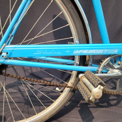 Sale Photo Thumbnail #187: Blue Schwinn Speedster with internal-gear drivetrain, full fenders, rear carrier, black saddle and rear reflector. Complete vintage rider showing paint chips, dull chrome, surface rust and older tires. A straightforward restoration or rider project with c