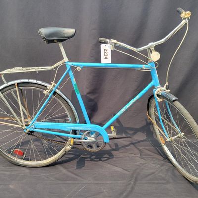 Sale Photo Thumbnail #186: Blue Schwinn Speedster with internal-gear drivetrain, full fenders, rear carrier, black saddle and rear reflector. Complete vintage rider showing paint chips, dull chrome, surface rust and older tires. A straightforward restoration or rider project with c
