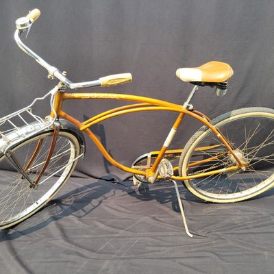 Sale Photo Thumbnail #201: Coppertone/orange Schwinn Corvette with whitewall tires, chrome front fender, missing rear fender, front rack, brown/cream saddle, bell and Corvette chainguard. Attractive survivor with a great original-style look and honest vintage patina. Shows normal p