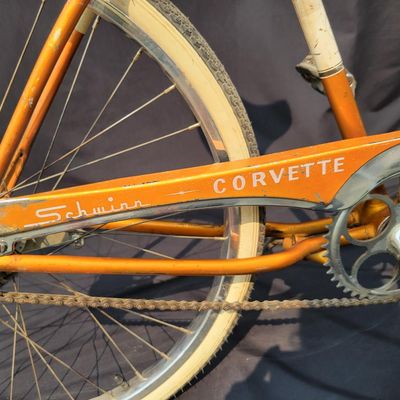 Sale Photo Thumbnail #197: Coppertone/orange Schwinn Corvette with whitewall tires, chrome front fender, missing rear fender, front rack, brown/cream saddle, bell and Corvette chainguard. Attractive survivor with a great original-style look and honest vintage patina. Shows normal p
