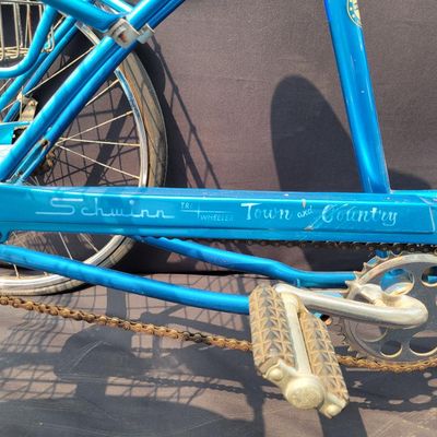 Sale Photo Thumbnail #203: Blue Schwinn Town & Country adult tricycle with step-through frame, large rear wire cargo basket, Town & Country chainguard, fenders, reflectors and black replacement saddle. Complete and useful vintage trike showing surface rust, basket corrosion, drivet
