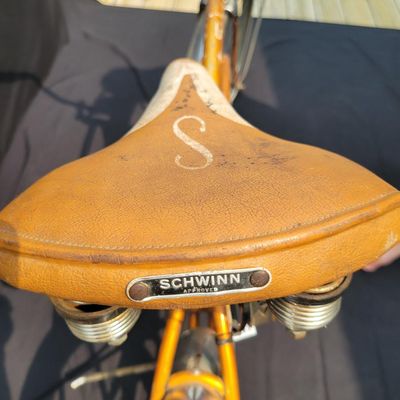 Sale Photo Thumbnail #227: Coppertone/orange Schwinn Corvette II with chrome fenders, front rack, bell/reflector equipment, brown saddle and whitewall tires. Attractive mid-1960s-style survivor with good completeness and plenty of original character. Shows normal paint wear, chrome