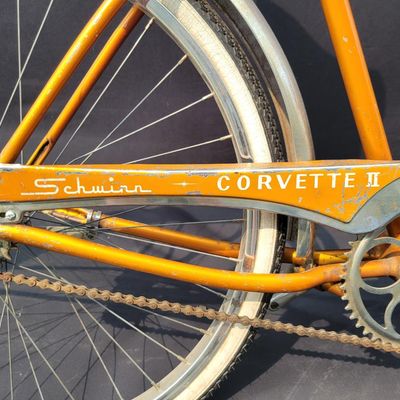 Sale Photo Thumbnail #221: Coppertone/orange Schwinn Corvette II with chrome fenders, front rack, bell/reflector equipment, brown saddle and whitewall tires. Attractive mid-1960s-style survivor with good completeness and plenty of original character. Shows normal paint wear, chrome