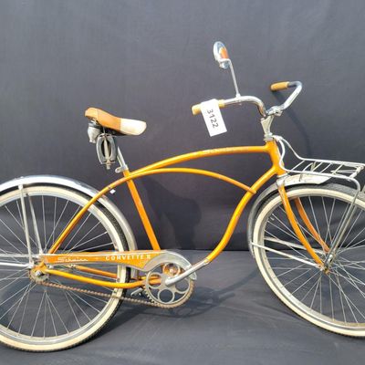 Sale Photo Thumbnail #220: Coppertone/orange Schwinn Corvette II with chrome fenders, front rack, bell/reflector equipment, brown saddle and whitewall tires. Attractive mid-1960s-style survivor with good completeness and plenty of original character. Shows normal paint wear, chrome