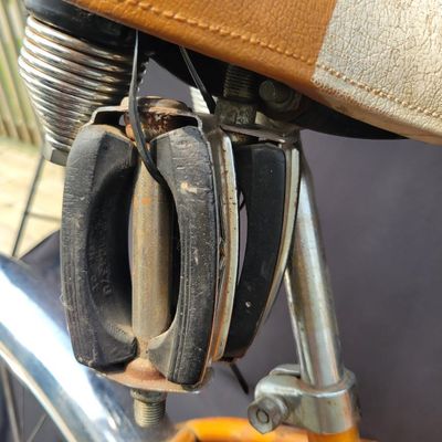 Sale Photo Thumbnail #222: Coppertone/orange Schwinn Corvette II with chrome fenders, front rack, bell/reflector equipment, brown saddle and whitewall tires. Attractive mid-1960s-style survivor with good completeness and plenty of original character. Shows normal paint wear, chrome