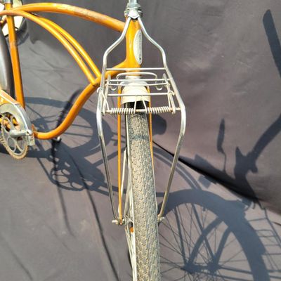 Sale Photo Thumbnail #226: Coppertone/orange Schwinn Corvette II with chrome fenders, front rack, bell/reflector equipment, brown saddle and whitewall tires. Attractive mid-1960s-style survivor with good completeness and plenty of original character. Shows normal paint wear, chrome