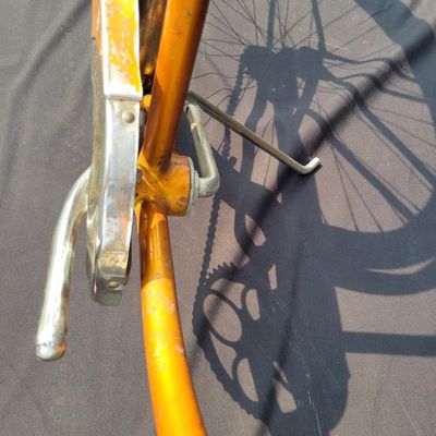 Sale Photo Thumbnail #223: Coppertone/orange Schwinn Corvette II with chrome fenders, front rack, bell/reflector equipment, brown saddle and whitewall tires. Attractive mid-1960s-style survivor with good completeness and plenty of original character. Shows normal paint wear, chrome
