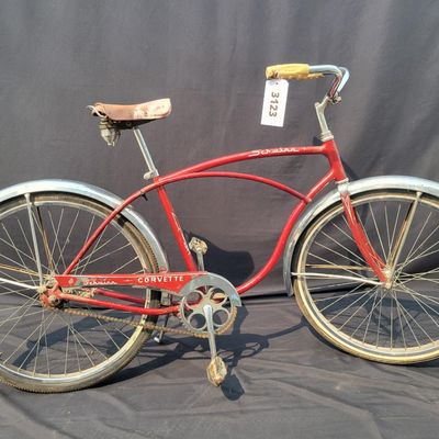 Sale Photo Thumbnail #228: Red Schwinn Corvette with chrome fenders, whitewall tires, brown saddle and Corvette chainguard. Complete vintage middleweight showing heavier cosmetic wear including faded/scratched graphics, paint chips and chrome oxidation. Good restoration candidate w