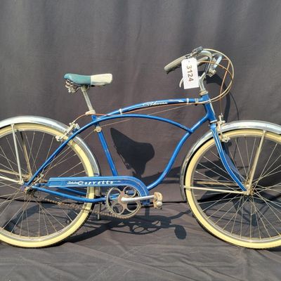 Sale Photo Thumbnail #231: Blue Schwinn Corvette with full fenders, whitewall tires and blue/white saddle. Complete and well-presented middleweight with moderate vintage patina, chrome aging and normal paint wear. A nice original-style example with good display or rider-restoration