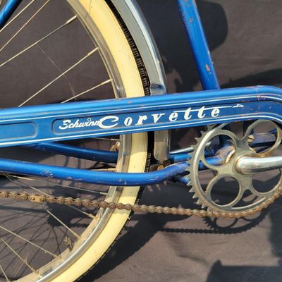 Sale Photo Thumbnail #232: Blue Schwinn Corvette with full fenders, whitewall tires and blue/white saddle. Complete and well-presented middleweight with moderate vintage patina, chrome aging and normal paint wear. A nice original-style example with good display or rider-restoration