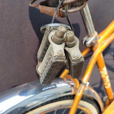 Sale Photo Thumbnail #239: Coppertone Schwinn Tiger with Tiger-marked chainguard, full fenders, brown saddle and bell. Classic mid-1960s Schwinn middleweight styling with good completeness and an attractive survivor look. Shows paint/chrome patina, saddle marks, aged tires and ligh