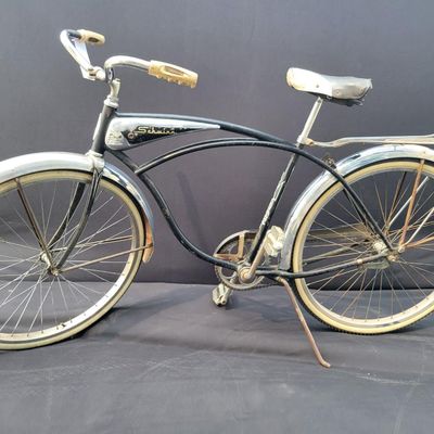 Sale Photo Thumbnail #251: Black Schwinn Panther III with chrome tank, full fenders, rear rack, whitewall tires and black/white saddle. Desirable deluxe Schwinn with excellent display presence and a largely complete configuration. Shows honest age including surface rust, paint wear