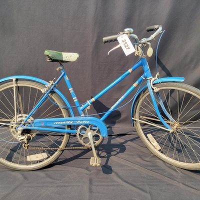 Sale Photo Thumbnail #252: Blue Schwinn Racer women's 3-speed with step-through frame, full fenders, chainguard and green/cream saddle. Complete vintage commuter showing surface rust, paint wear, chrome oxidation and age to the saddle and tires. A good rider-restoration project wit