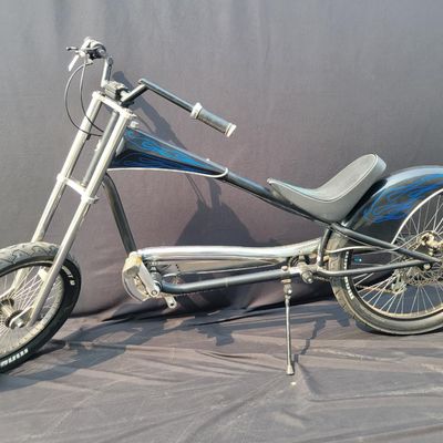 Sale Photo Thumbnail #266: Giant Stiletto production chopper/cruiser in black with blue flame graphics. Features the stretched steel frame, oversized dual-crown fork, 20-inch front and 24-inch rear 3-inch tires, 7-speed drivetrain with Shimano Altus rear derailleur, rear disc brake