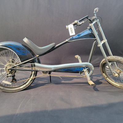 Sale Photo Thumbnail #260: Giant Stiletto production chopper/cruiser in black with blue flame graphics. Features the stretched steel frame, oversized dual-crown fork, 20-inch front and 24-inch rear 3-inch tires, 7-speed drivetrain with Shimano Altus rear derailleur, rear disc brake