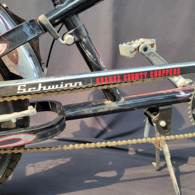 Sale Photo Thumbnail #268: Schwinn Orange County Choppers Sting-Ray in black, red and silver with extended chopper fork, low saddle, rear suspension, ape-style bars, dual mirrors, chrome headlamp and fenders. Complete early-2000s OCC-style bike with strong novelty and collector app