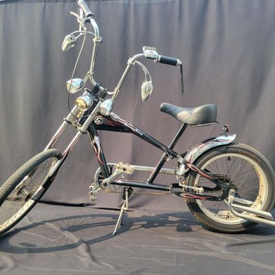 Sale Photo Thumbnail #276: Schwinn Orange County Choppers Sting-Ray in black, red and silver with extended chopper fork, low saddle, rear suspension, ape-style bars, dual mirrors, chrome headlamp and fenders. Complete early-2000s OCC-style bike with strong novelty and collector app