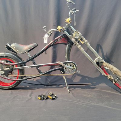 Sale Photo Thumbnail #277: Large adult-size Schwinn Sting-Ray Spoiler chopper with long springer/girder-style front end, black frame with red flame graphics, red wheels, fat rear tire, flame saddle, mirrors and headlamp-style accessories. Much larger and scarcer than the common you