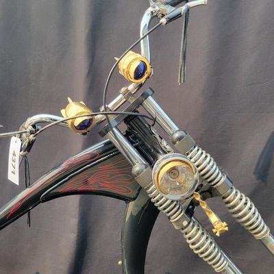 Sale Photo Thumbnail #281: Large adult-size Schwinn Sting-Ray Spoiler chopper with long springer/girder-style front end, black frame with red flame graphics, red wheels, fat rear tire, flame saddle, mirrors and headlamp-style accessories. Much larger and scarcer than the common you