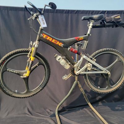 Sale Photo Thumbnail #290: 1996 Trek Y33 OCLV carbon full-suspension mountain bike with distinctive carbon Y-frame, yellow suspension linkage/fork, rear shock, multi-speed drivetrain and premium Spinergy composite tri-spoke wheels. Includes water bottle, mirror and rear rack/bag. A