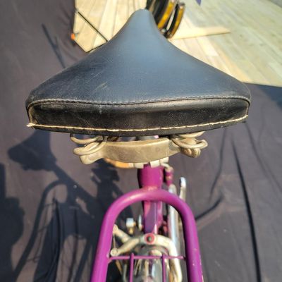 Sale Photo Thumbnail #301: Purple/magenta Bianchi folding bicycle with 20-inch wheels, center folding hinge, Bianchi graphics, chrome fenders, rear rack, tan-sidewall tires, high handlebars and twin front light/reflector accessories. Distinctive and substantially complete with grea