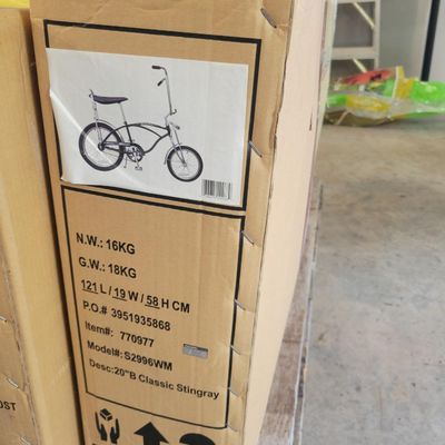 Sale Photo Thumbnail #311: Boxed Pacific Cycle-era Schwinn Classic Sting-Ray reproduction, model S2996WM, finished in black/chrome. Original-style factory carton is present and shows normal storage and handling wear. Bicycle remains boxed/unassembled and the contents have not been 