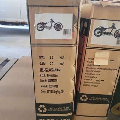 Sale Photo Thumbnail #321: Boxed Schwinn Orange County Choppers Sting-Ray CP chopper, model S2910WM, in chrome/red. Factory carton shows the classic long-fork OCC-style 20-inch Sting-Ray and carries model/item labeling. Bicycle remains boxed/unassembled and the carton shows shelf w