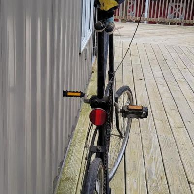 Sale Photo Thumbnail #336: One-of-a-kind custom tallbike built from stacked/welded bicycle frames and finished primarily in black. Fitted with multi-speed rear derailleur, front hand brake, high seating position and a full assortment of skull/pirate decorations, flags, tassels and 