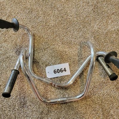 Sale Photo Thumbnail #352: Lot of two chrome cruiser/high-rise bicycle handlebar sets with assorted black grips, both sets are stamped SCHWINN. One set is Stamped SCHWINN RAMSHORN. Used condition with scratches, grip wear and light chrome patina. Good parts lot for cruiser, muscle-