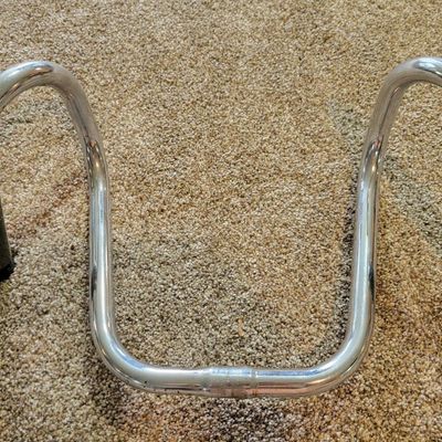 Sale Photo Thumbnail #355: Lot of two chrome cruiser/high-rise bicycle handlebar sets with assorted black grips, both sets are stamped SCHWINN. One set is Stamped SCHWINN RAMSHORN. Used condition with scratches, grip wear and light chrome patina. Good parts lot for cruiser, muscle-