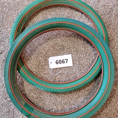 Sale Photo Thumbnail #370: Pair of vintage Goodyear green bicycle tires,Front Wingfoot size 20 x 1.75, and Rear Grasshopper Slick size 20 x 2.125 with contrasting orange/red sidewall stripe. Sidewalls are marked GOODYEAR and POLYESTER. Great visual fit for a vintage muscle-bike, cu