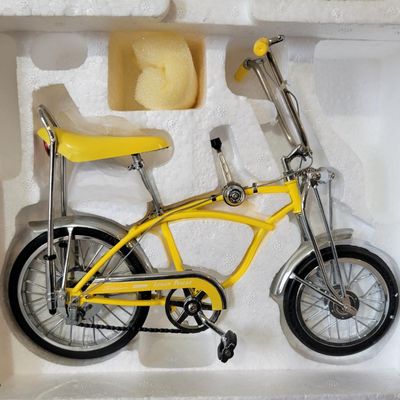 Sale Photo Thumbnail #391: Xonex 1:6 scale 1969 Schwinn Sting-Ray Lemon Peeler Krate in yellow. Includes molded Styrofoam insert and original retro-style presentation carton. Model presents well with classic Krate detailing; packaging shows scuffs, creases and edge/corner wear from
