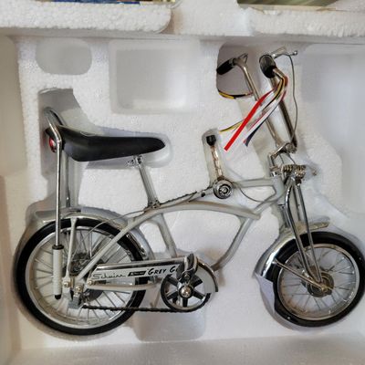 Sale Photo Thumbnail #400: Boxed Xonex 1:6 scale Schwinn Sting-Ray Grey Ghost Krate die-cast model in silver/gray with black-and-silver banana seat and detailed Krate styling. Includes molded Styrofoam insert and original Grey Ghost presentation carton. Model presents well with exp