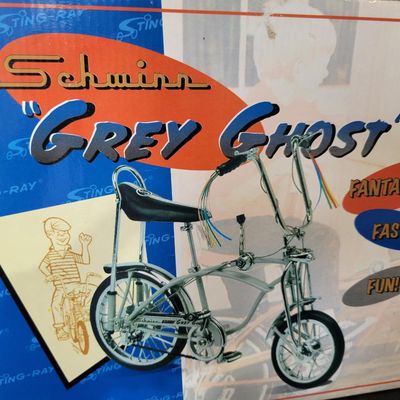 Sale Photo Thumbnail #399: Boxed Xonex 1:6 scale Schwinn Sting-Ray Grey Ghost Krate die-cast model in silver/gray with black-and-silver banana seat and detailed Krate styling. Includes molded Styrofoam insert and original Grey Ghost presentation carton. Model presents well with exp