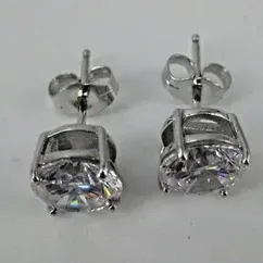 Sale Photo Thumbnail #219: Sterling Silver Earrings Round 7mm Cubic Zirconia Stud Butterfly Fastening 3/8" 
Weighs 2.4 g / 1.5 dwt 
Earrings Measure: 3/8" in diameter
Clear CZ stones: round, faceted, prong-set: 7mm in diameter each
Closure: Butterfly Fastening 
Hallmarks: CZ 925 
C