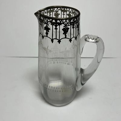 Sale Photo Thumbnail #165: Antique Silver Overlay Early Etched Leaded Glass Pitcher 9-3/4" Tall in VG Preowned Condition. $15 Domestic Shipping.
