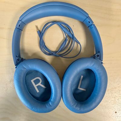 Sale Photo Thumbnail #287: Over-ear design with plush cushioned earcups, active noise cancellation, adjustable ambient modes, and up to 24 hours of battery life per charge. Supports both wireless Bluetooth pairing and wired audio using the included 3.5mm to 2.5mm audio cable shown.
