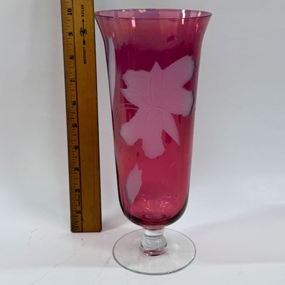 Sale Photo Thumbnail #122: Vintage ruby cranberry flash glass vase features a delicate white etched floral design. Good condition, approx. 10" tall.