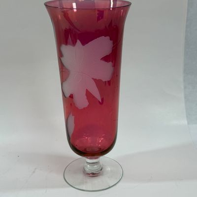 Sale Photo Thumbnail #117: Vintage ruby cranberry flash glass vase features a delicate white etched floral design. Good condition, approx. 10" tall.