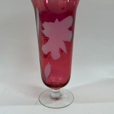 Sale Photo Thumbnail #115: Vintage ruby cranberry flash glass vase features a delicate white etched floral design. Good condition, approx. 10" tall.