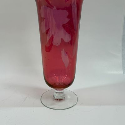 Sale Photo Thumbnail #119: Vintage ruby cranberry flash glass vase features a delicate white etched floral design. Good condition, approx. 10" tall.