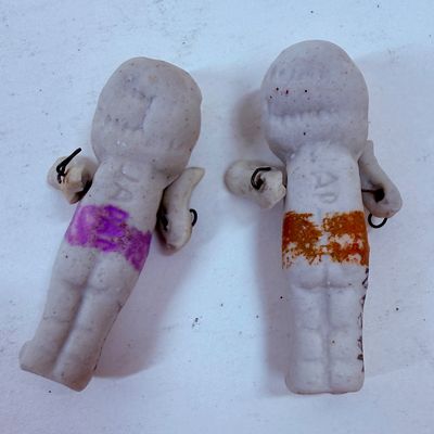 Sale Photo Thumbnail #484: Often called "penny dolls," "frozen Charlotte" dolls, or Kewpie dolls.  Commonly manufactured around the 1930s. The dolls frequently feature jointed arms attached with small metal wires, allowing them to move.T hey were often sold as carnival prizes or di