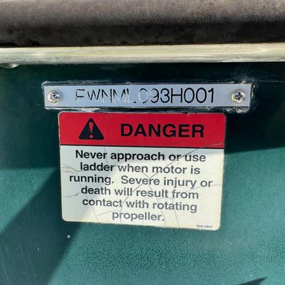 Sale Photo Thumbnail #24: Includes everything pictured, including Four Winns trailer. Johnson 150hp Ocean Pro outboard motor, production date 8/2000. Eighteen foot hull. The motor turns over, but is not firing. The engine cowling has a crack (pictured). This boat is pretty clean. 