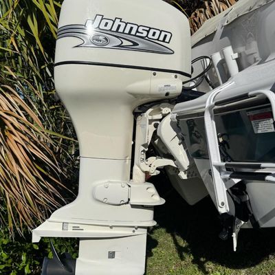 Sale Photo Thumbnail #25: Includes everything pictured, including Four Winns trailer. Johnson 150hp Ocean Pro outboard motor, production date 8/2000. Eighteen foot hull. The motor turns over, but is not firing. The engine cowling has a crack (pictured). This boat is pretty clean. 