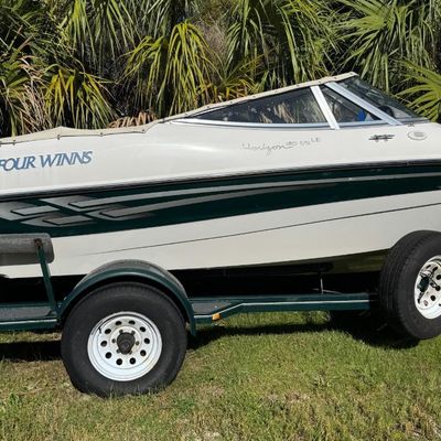Sale Photo Thumbnail #23: Includes everything pictured, including Four Winns trailer. Johnson 150hp Ocean Pro outboard motor, production date 8/2000. Eighteen foot hull. The motor turns over, but is not firing. The engine cowling has a crack (pictured). This boat is pretty clean. 